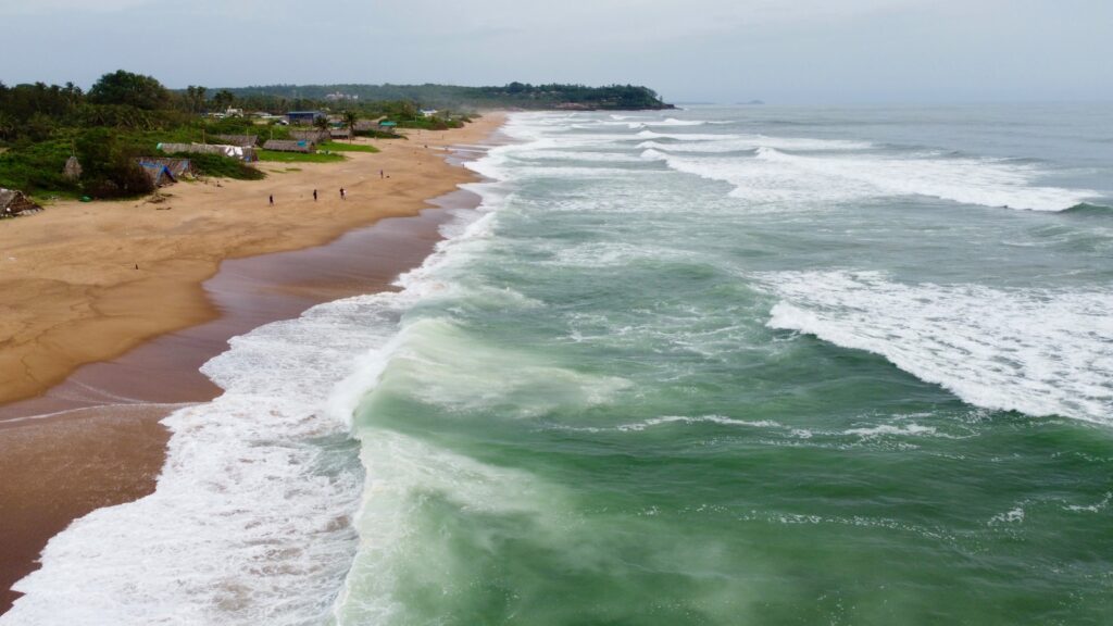 candolim - a beach with waves crashing on it