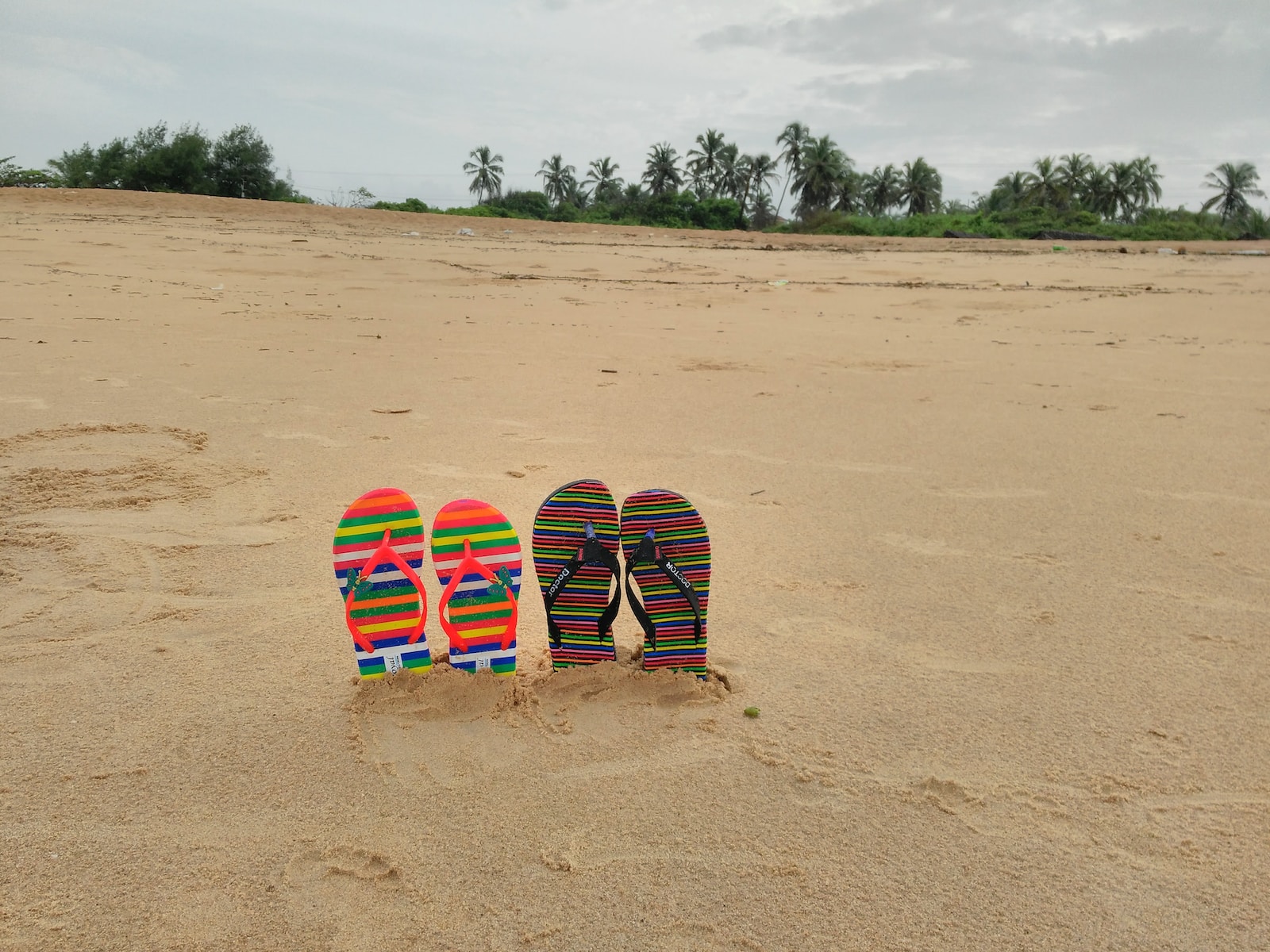 a group of surfboards on a sandy beach candolim , Goa