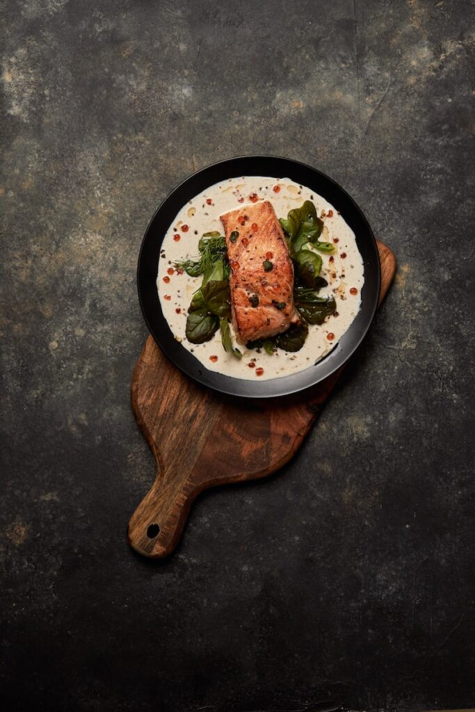 brown wooden round plate with food fish food